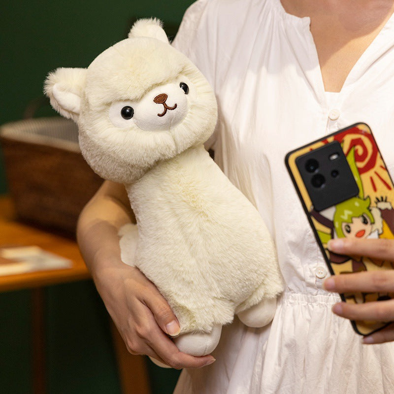 A person in a white shirt holds the ZoDoll Cute Alpaca Plush Doll – Soft Alpaca Plush Toy and a smartphone with an illustrated case.