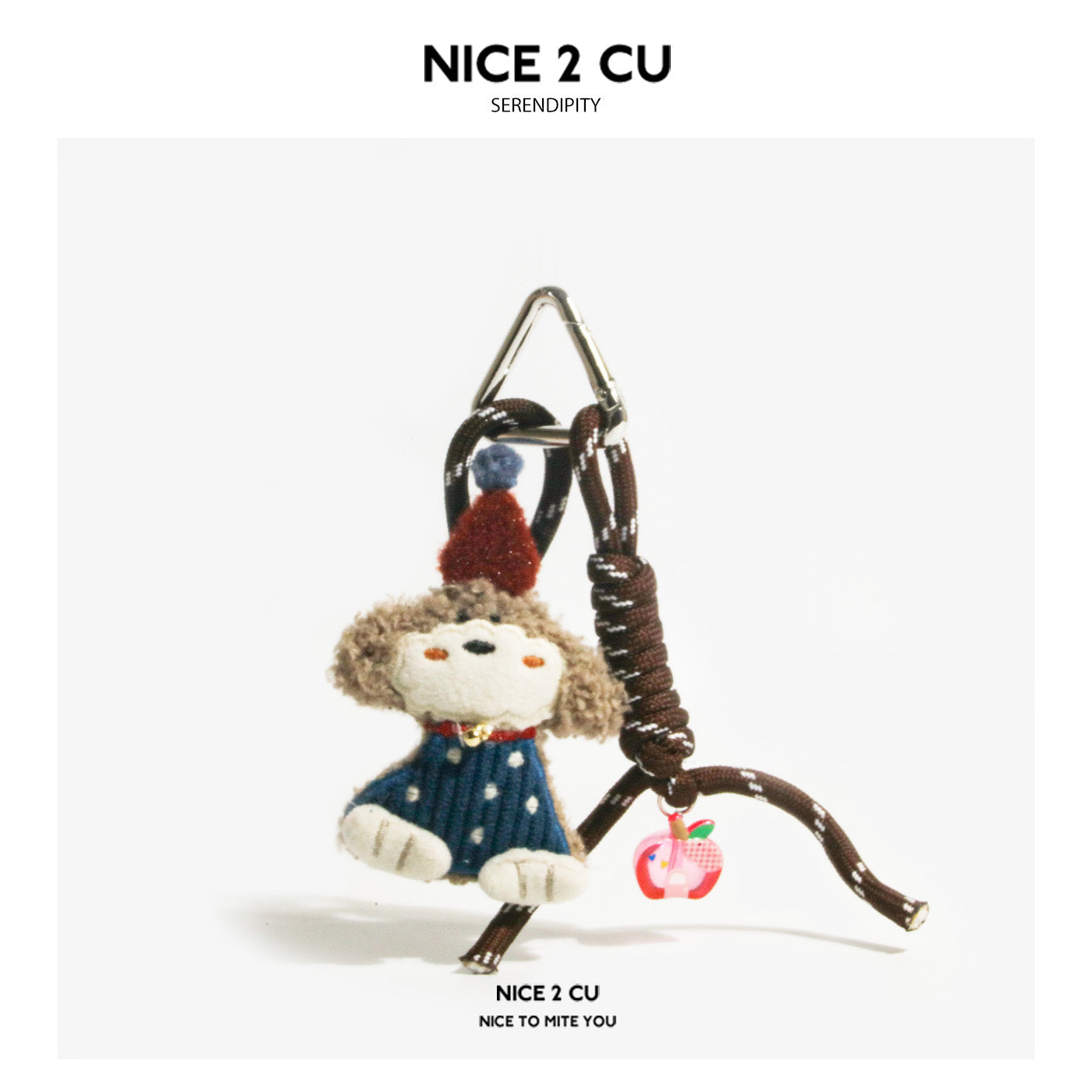 Curly-haired tan dog plush charm in blue dotted outfit with red hat and pink side charm