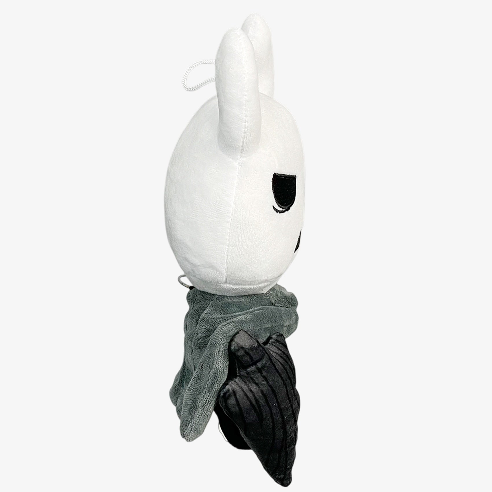 Side view of the Officially Licensed Hollow Knight Plush Doll—a white horned bug warrior with gray cloak and nail weapon, 10.24 inches tall—an ideal collectible from Hollow Knight.