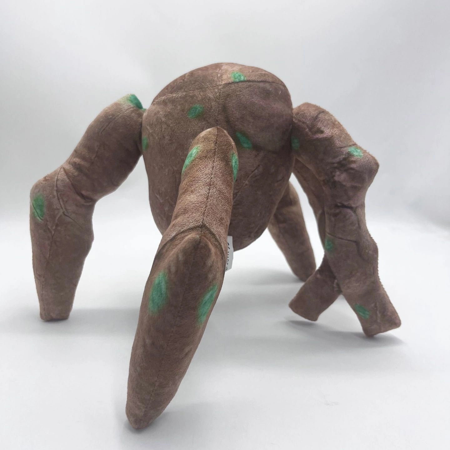 The ZoDoll Rocky Plush Project Hail Mary 20.2cm Alien Companion stuffed toy stands on a white background, featuring a brown body, four legs, and green spots, inspired by Project Hail Mary.