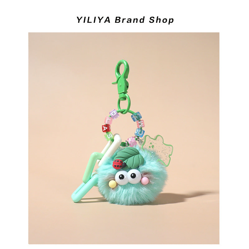 Mint green fluffy pom-pom charm with green small clip attachment, pastel beads, glittery flower outline, and ladybug leaf top