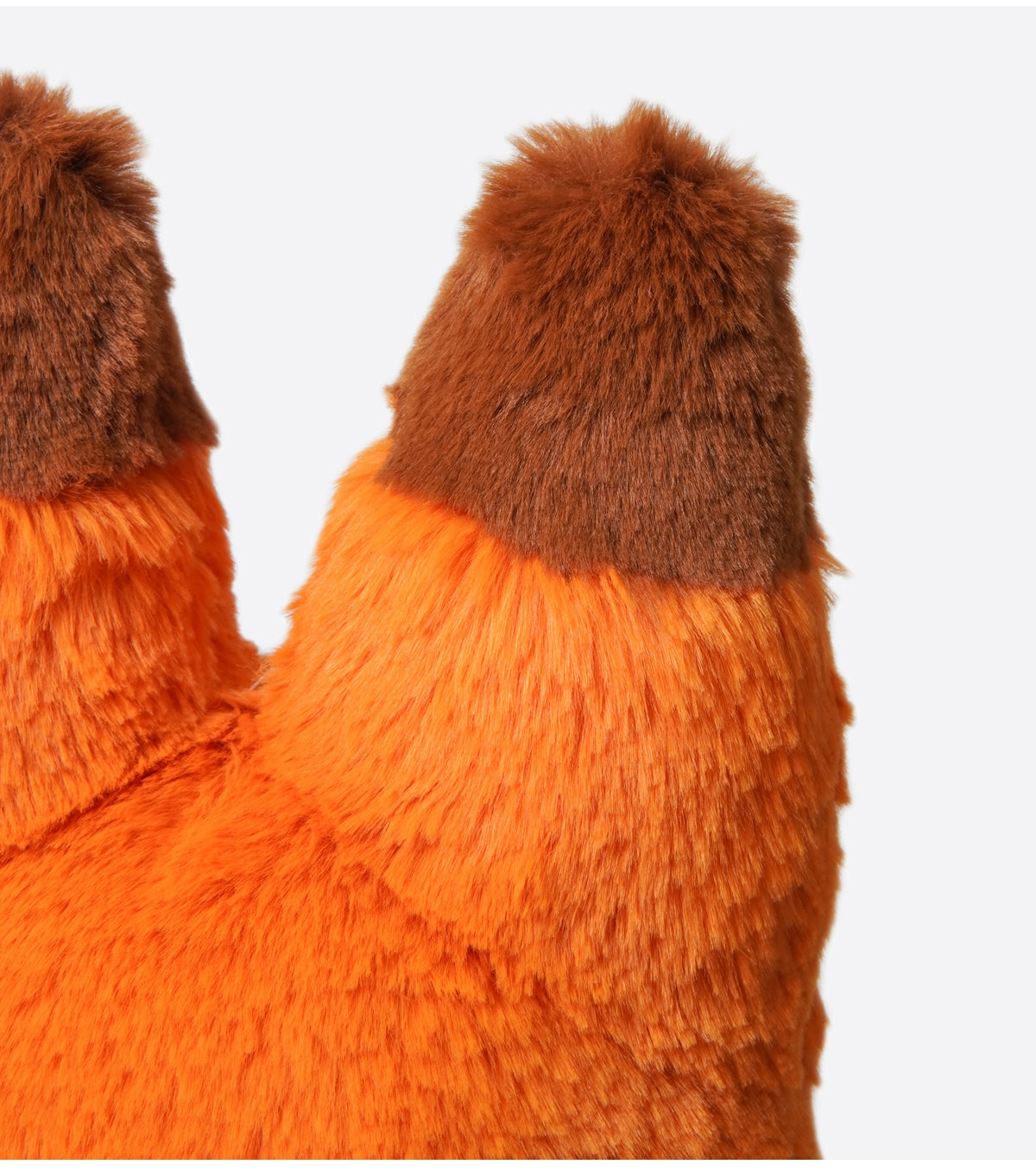 Close-up of two orange ears with dark brown tips from the ZEIO Fox Plush Toy 42cm, a soft large stuffed animal with a fluffy tail, set against a plain light background.