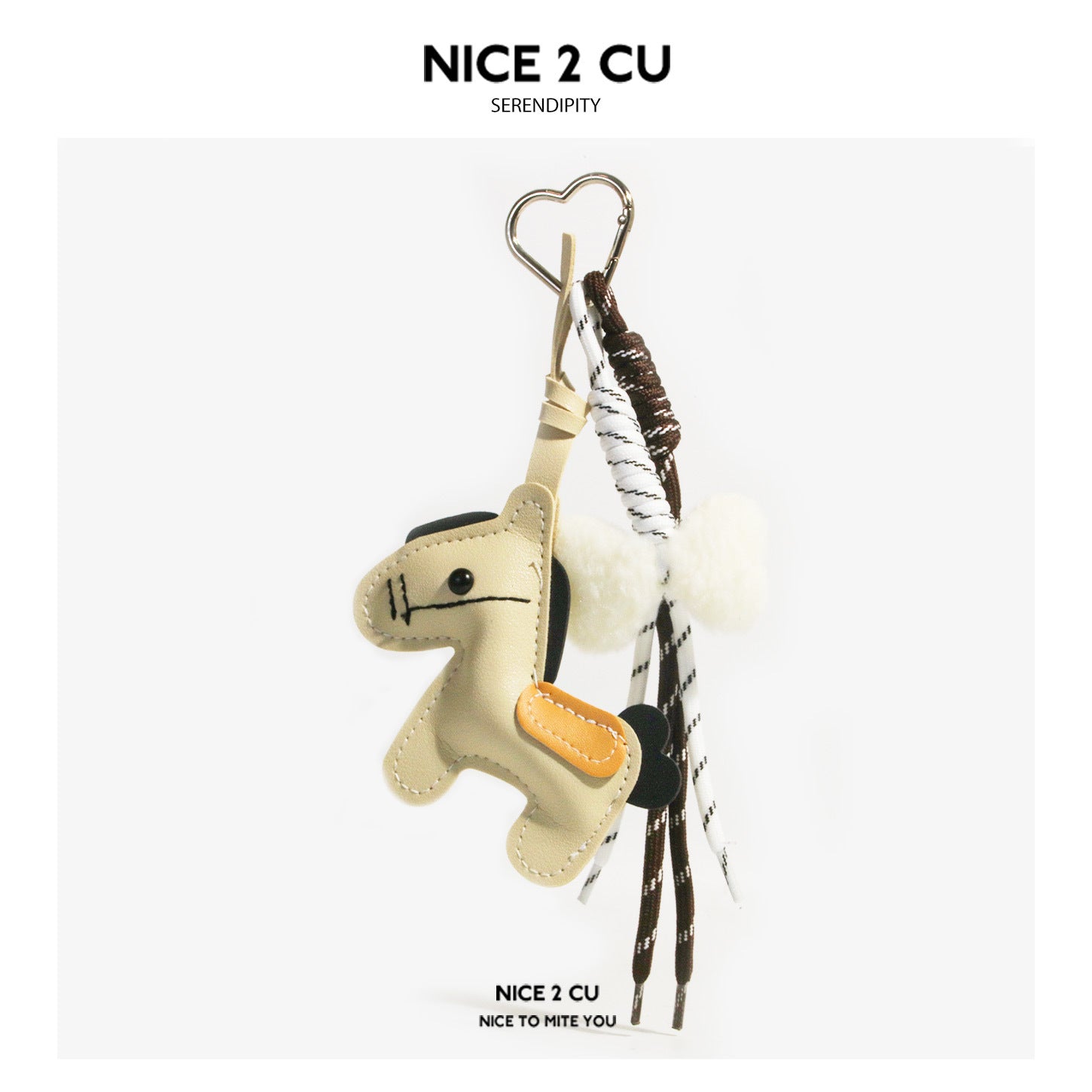 Cream horse bag charm keychain with black mane accents, yellow saddle detail, heart clasp, and braided cord