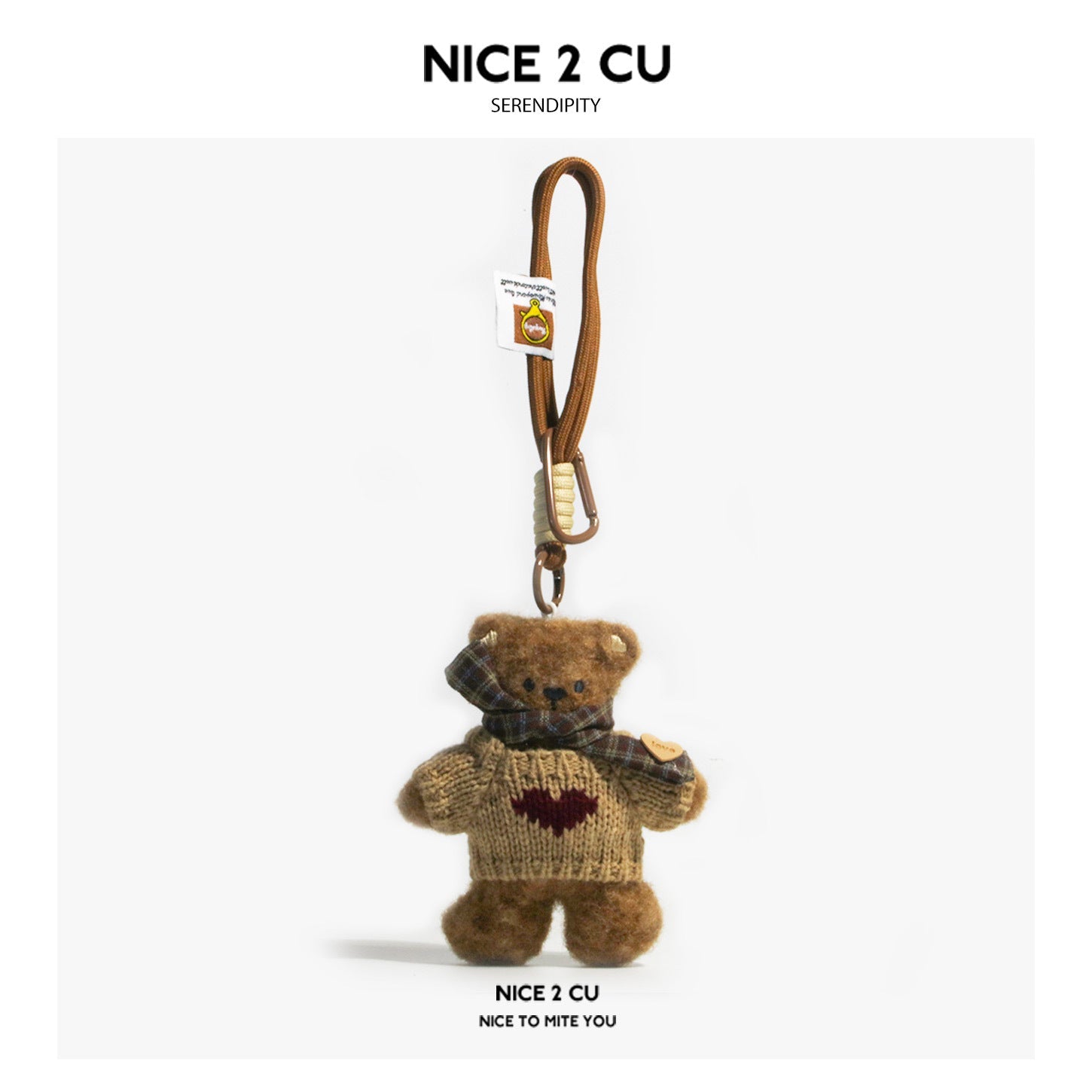Serendipity Dirty Bear bag charm in khaki sweater with dark red heart motif and brown plaid scarf on cord loop