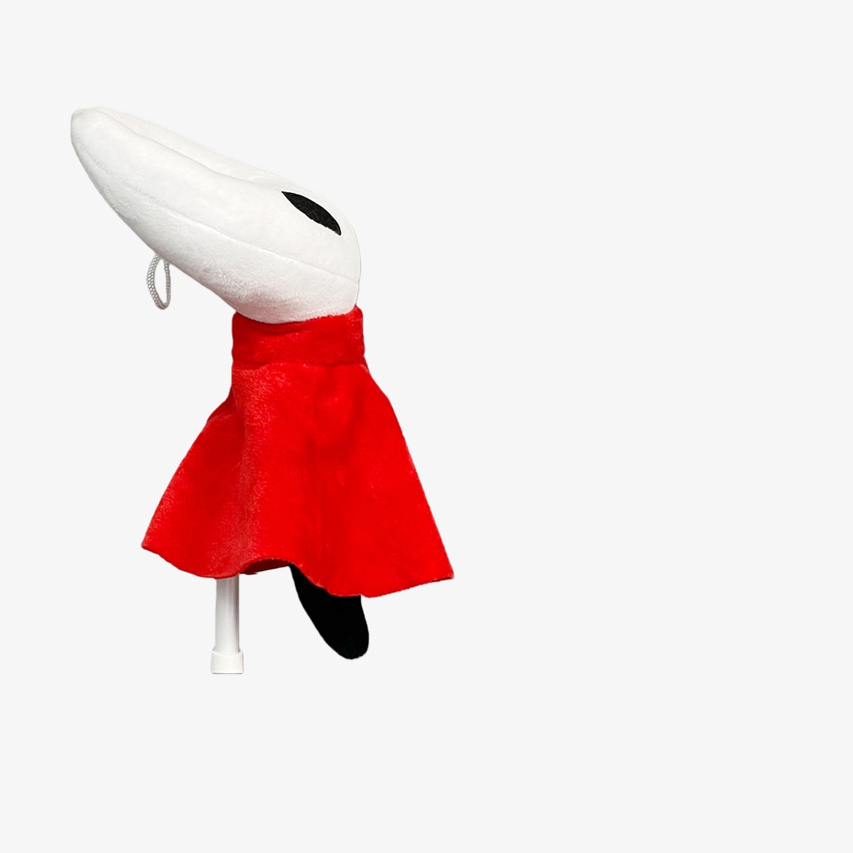 The Hollow Knight Officially Licensed Plush Doll features the White Mask Bug Character with black eyes, a red cloak, and black tail. This 9.45-inch soft collectible stuffed toy is perfect for fans seeking authentic merchandise.