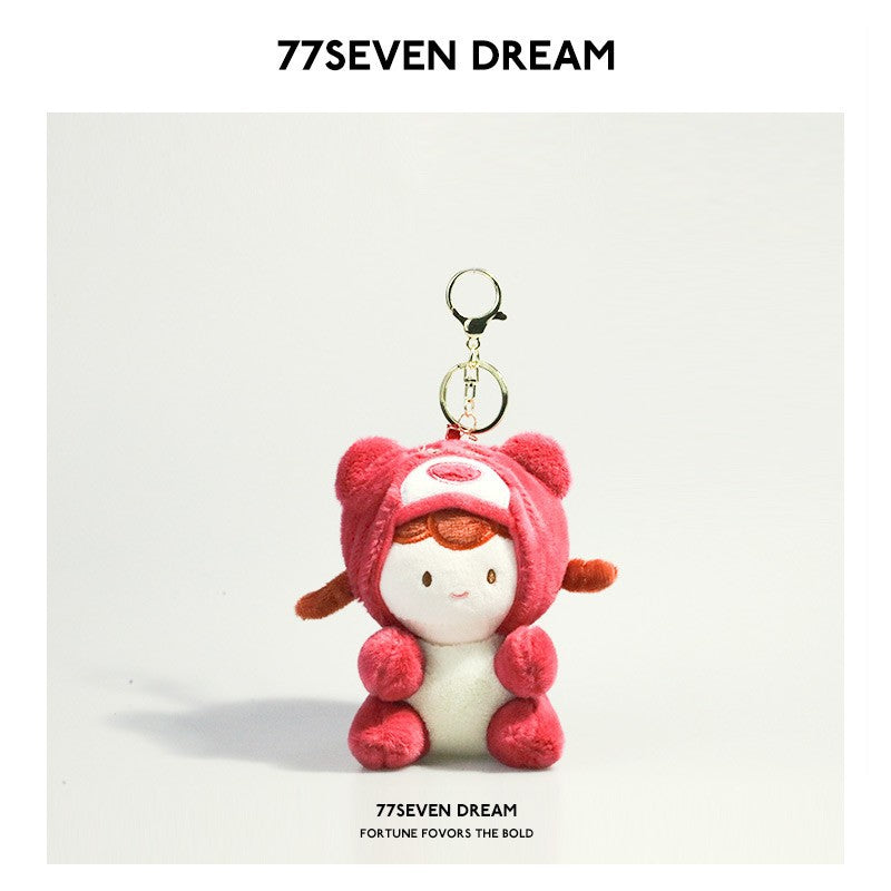 Kawaii plush keychain charm with girl doll face in a dark pink bear hood costume and gold ring attachment