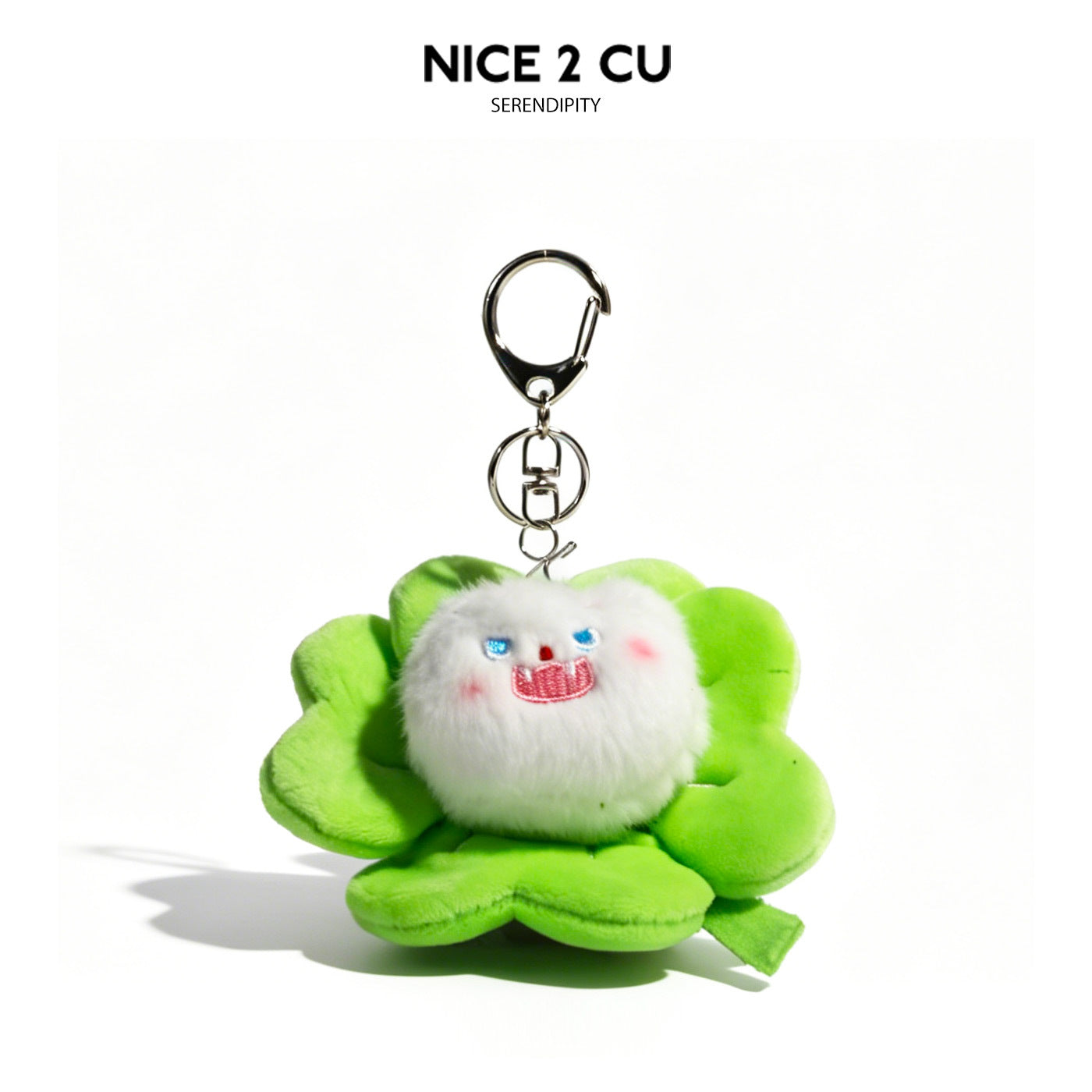White fluffy cat plush keychain charm centered in a bright green four-leaf clover with silver lobster-claw clasp