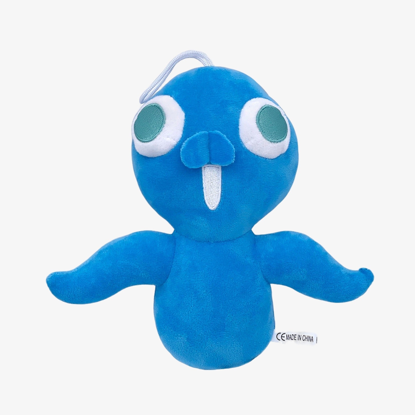 The Amazing Digital Circus Inspired Plush Toy is an 8.3-inch blue cartoon character doll with big green-and-white eyes, a long white felt tooth, and two outstretched arms—a soft stuffed figure by The Amazing Digital Circus brand.