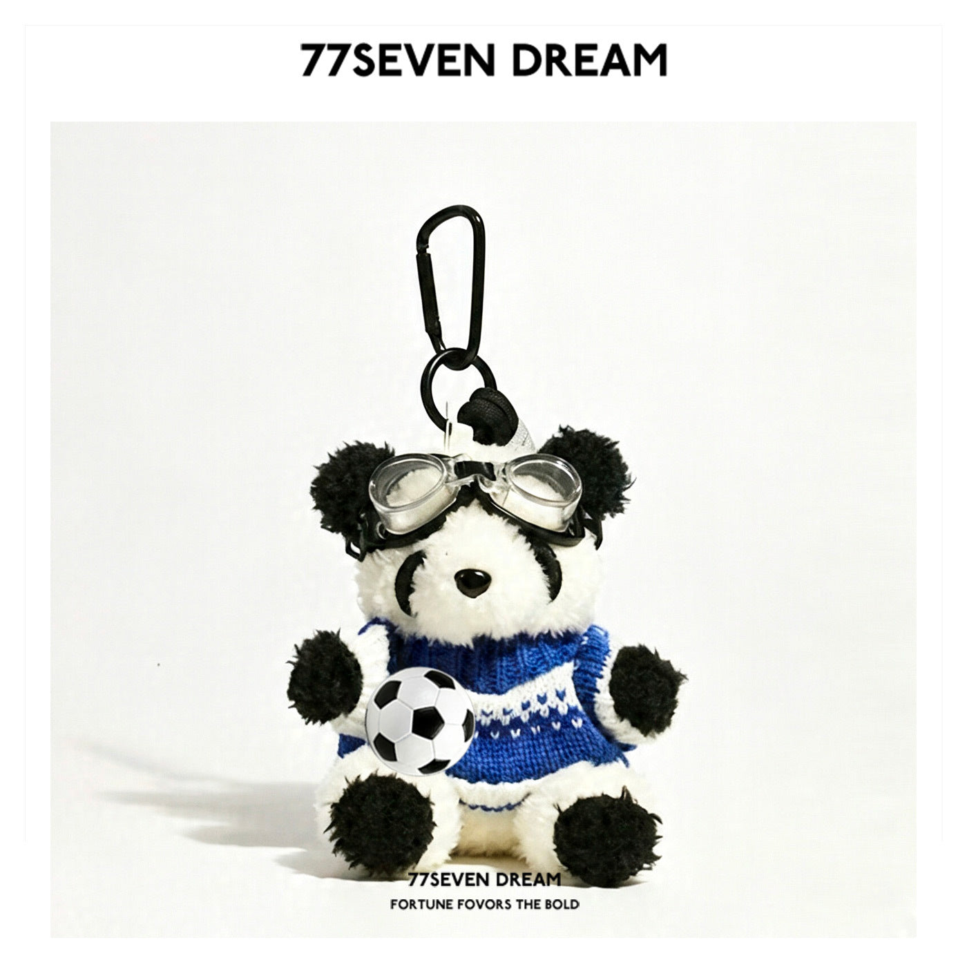 Panda plush bag charm wearing a blue patterned knit sweater with white decorative bands and clear goggles