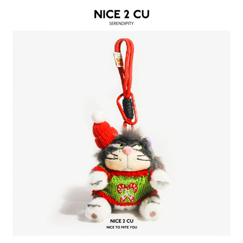 Grumpy cat plush charm wearing a green knitted gingerbread man sweater and red Santa hat with white pom-pom