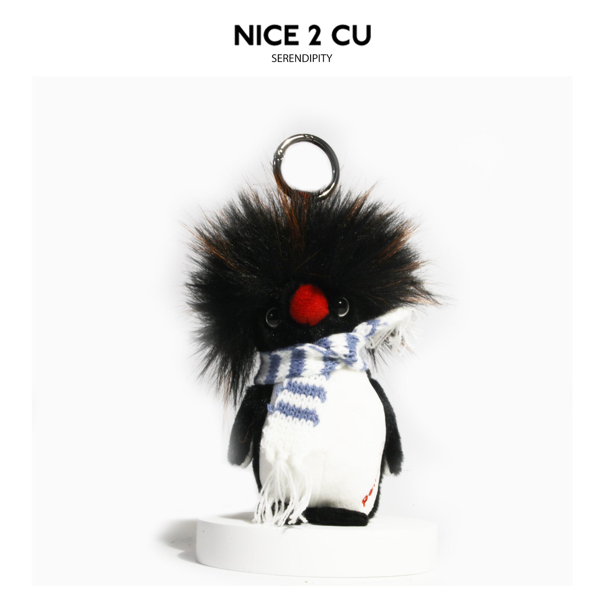 Fluffy penguin plush charm with blue-and-white striped fringed scarf and metal hanging loop