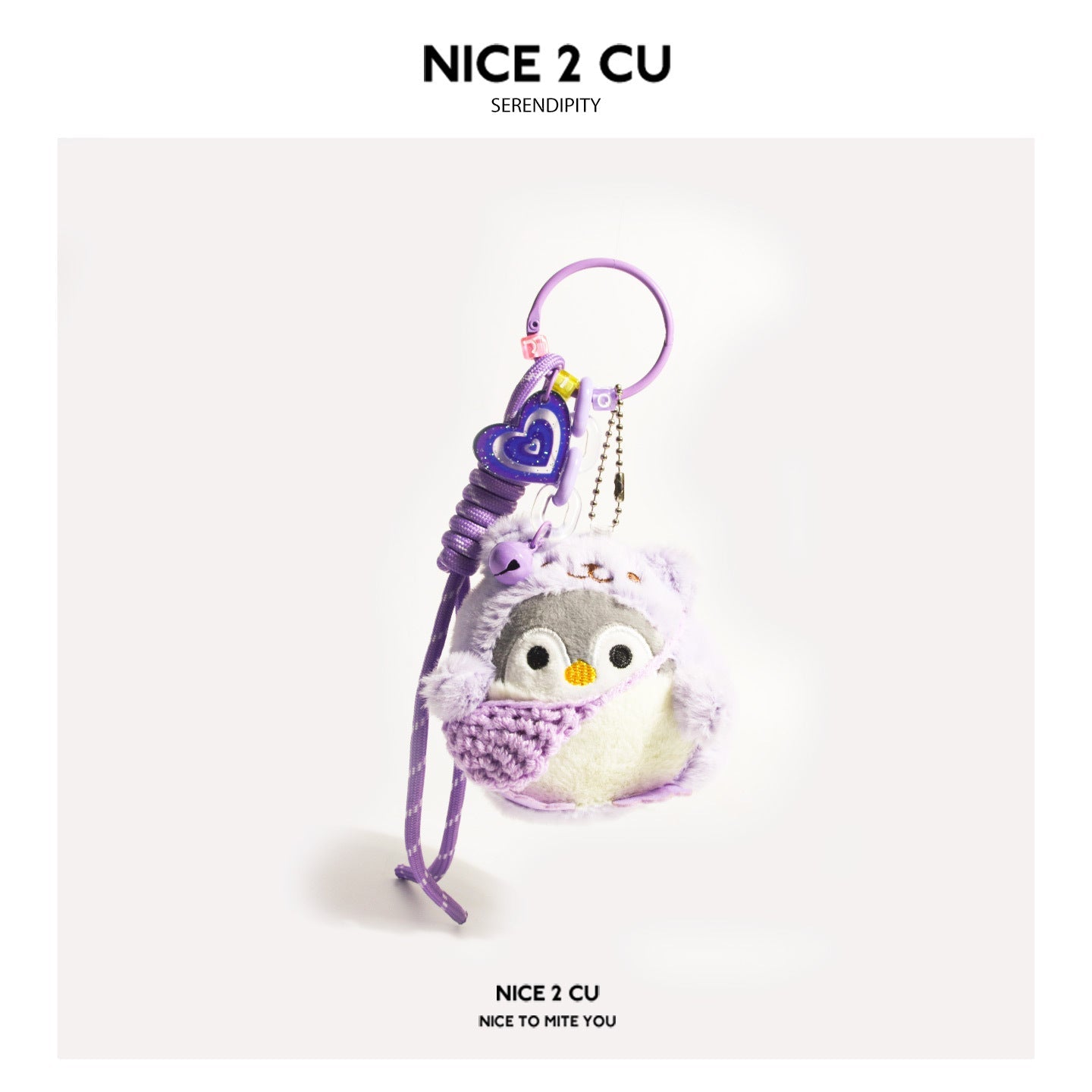 Purple plush penguin keychain charm with heart-shaped accent and layered decorative chain