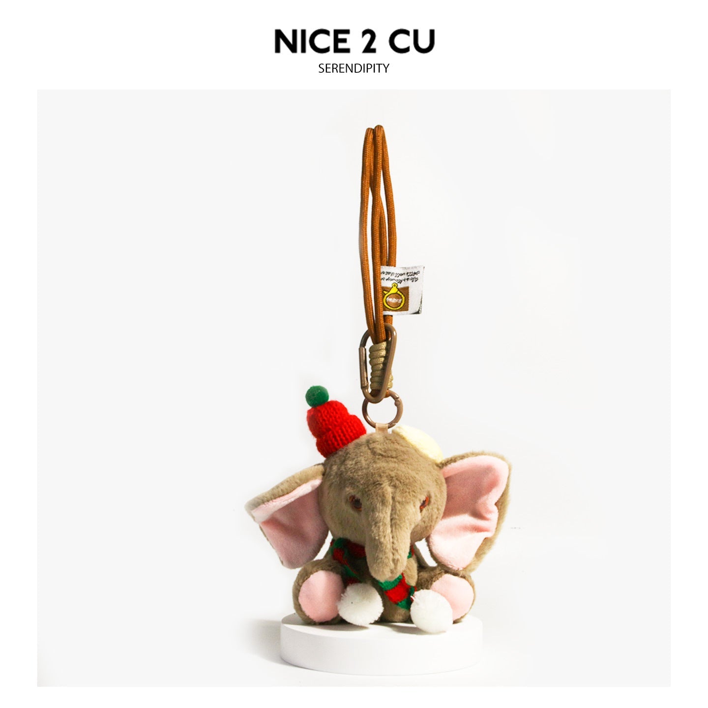 Coffee-brown plush elephant charm wearing a red-and-green knitted scarf with white pompoms and a brown hanging strap
