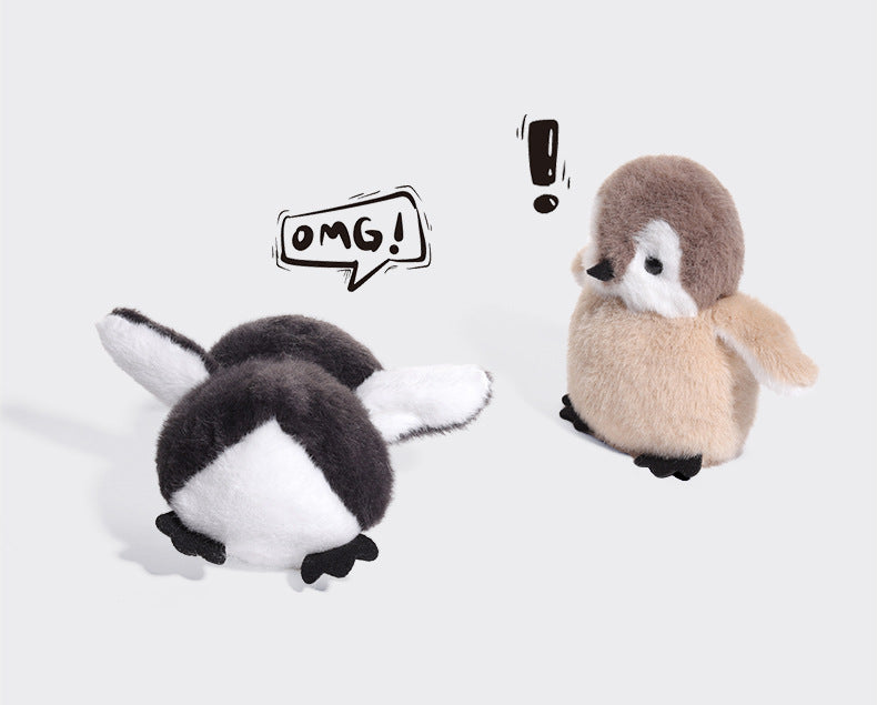 Two JOOKI 20cm Baby Penguin Plush Toys, with soft grey and white fur, on a white background—one faces forward with an exclamation mark overhead, the other lies face down with an "OMG!" bubble, adding playful charm to nursery decor.