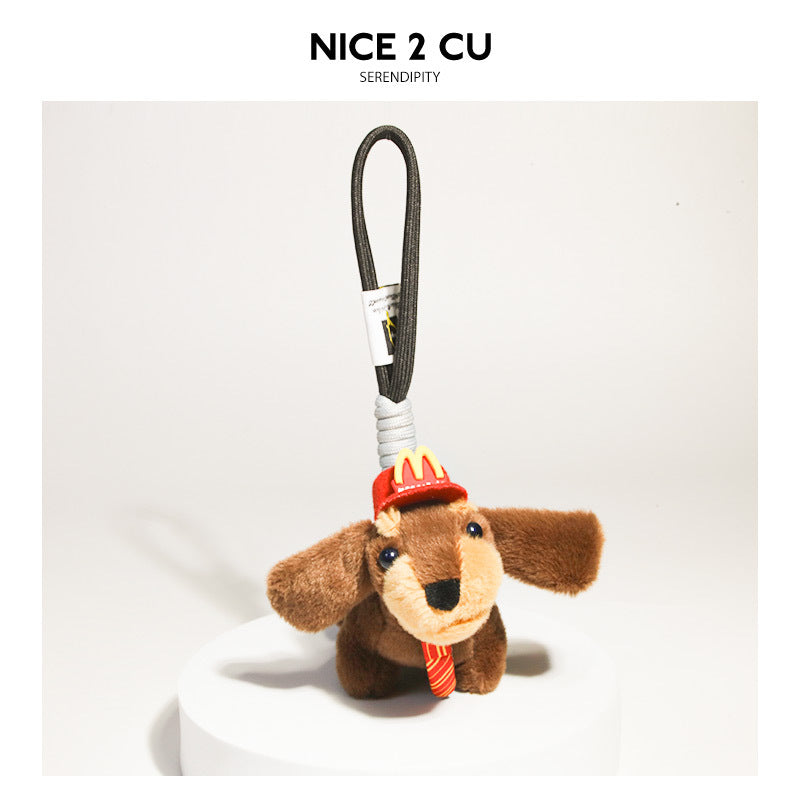 Plush dachshund keychain with red cap, yellow logo, striped tie, and black cord loop