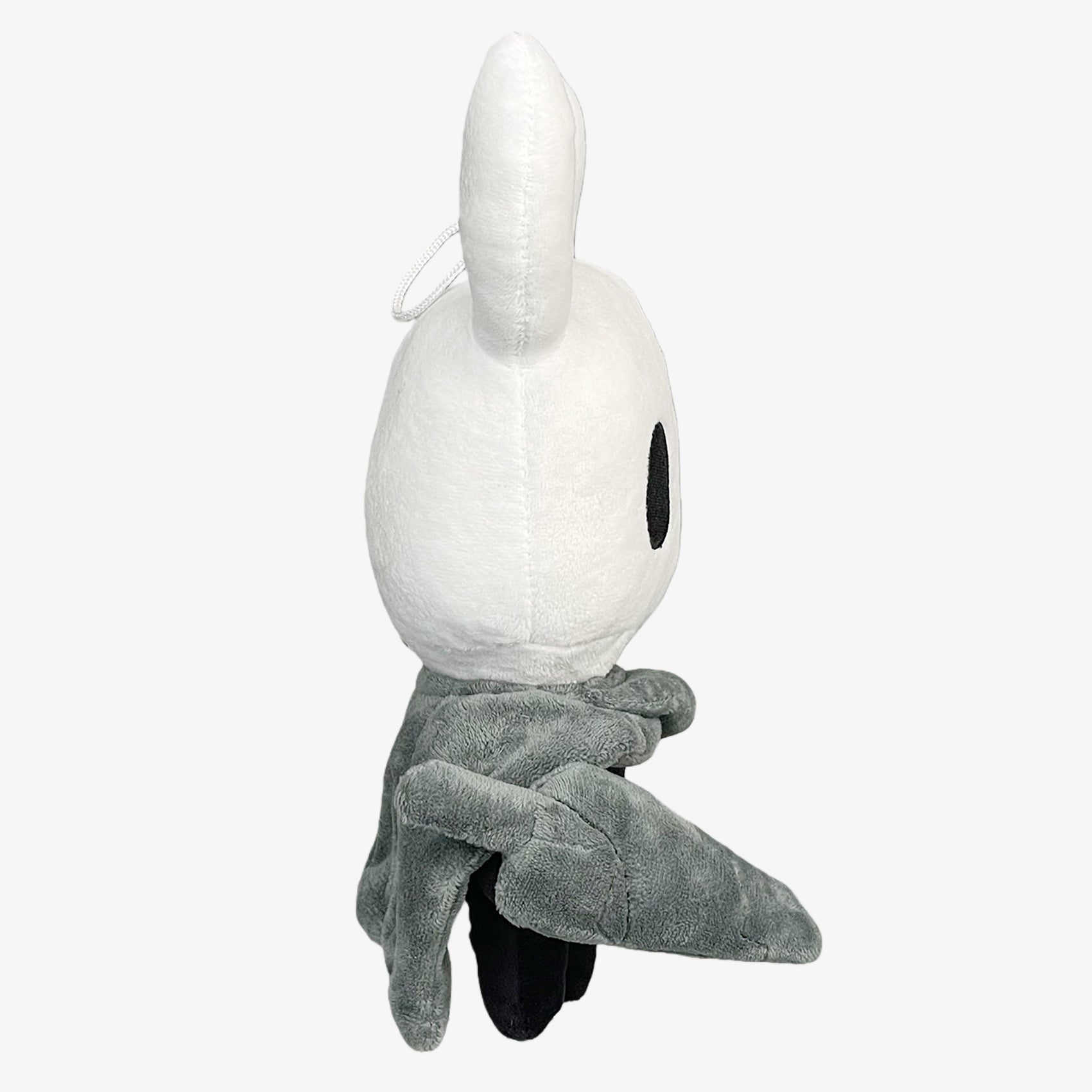The Officially Licensed Hollow Knight Plush Doll by Hollow Knight features the classic white horned bug character with black eyes and a gray cloak. This 10.24-inch soft collectible stuffed toy is perfect for fans and collectors.