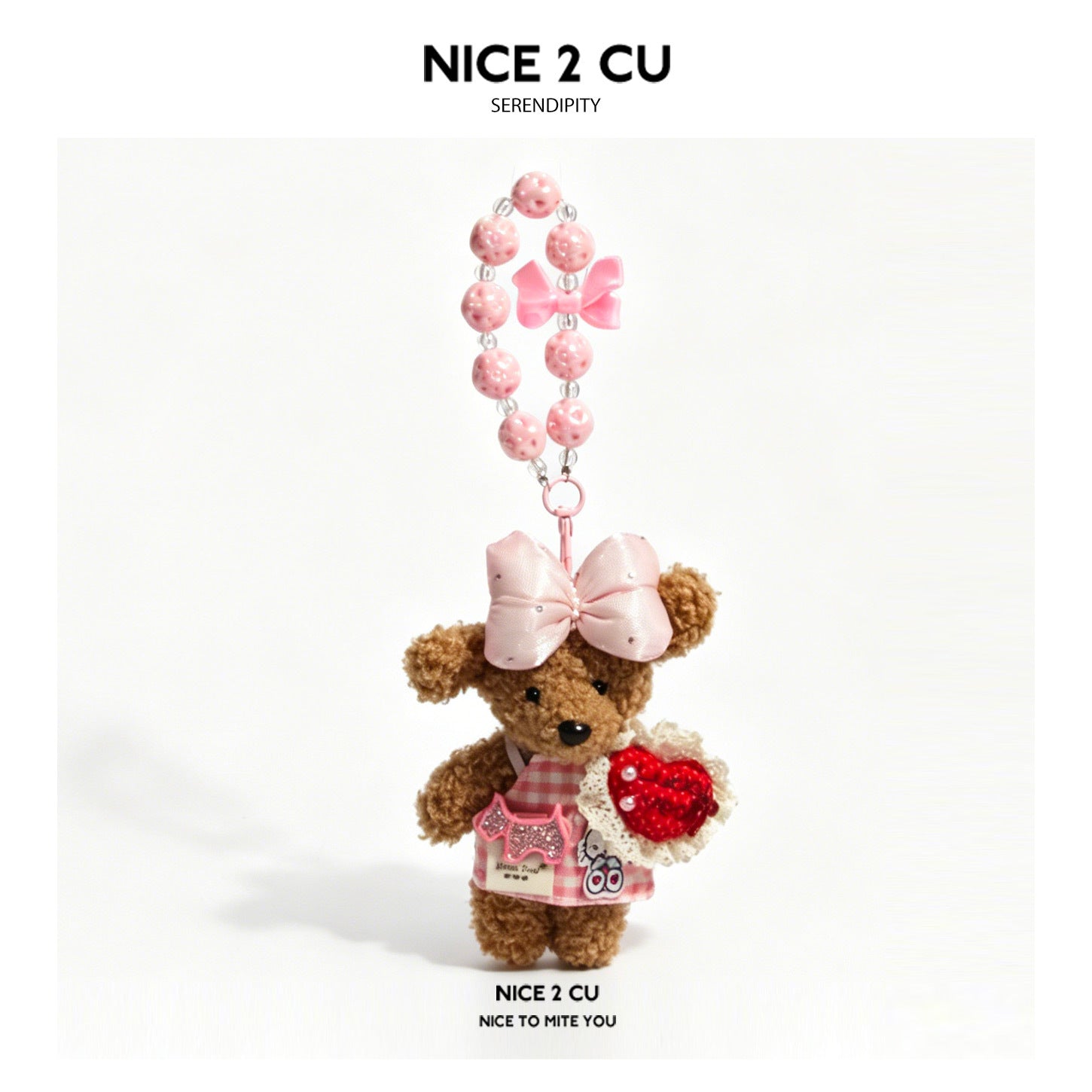 Brown teddy-style plush dog charm with a pink beaded necklace strap, pink head bow, and red heart decoration