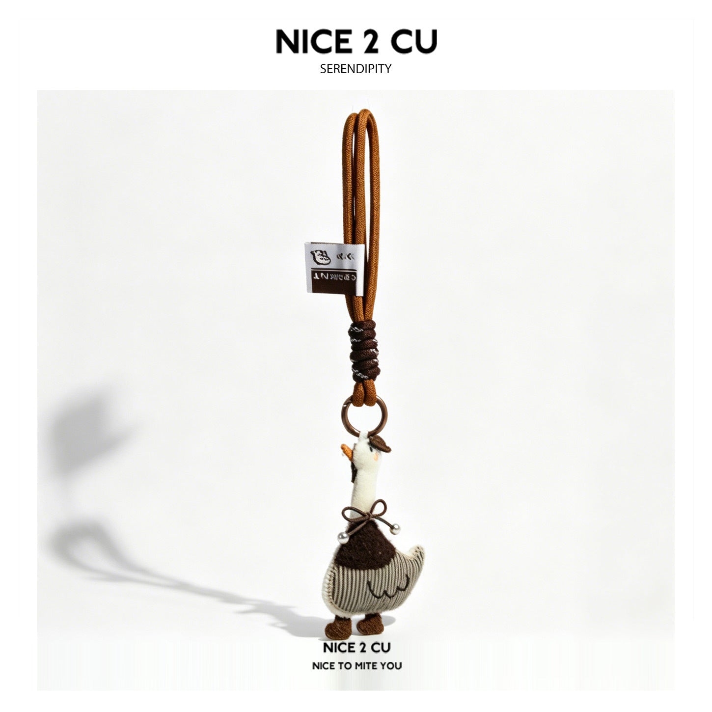 Cream and brown duck plush charm with small hat, striped body, and bow detail on a brown rope strap