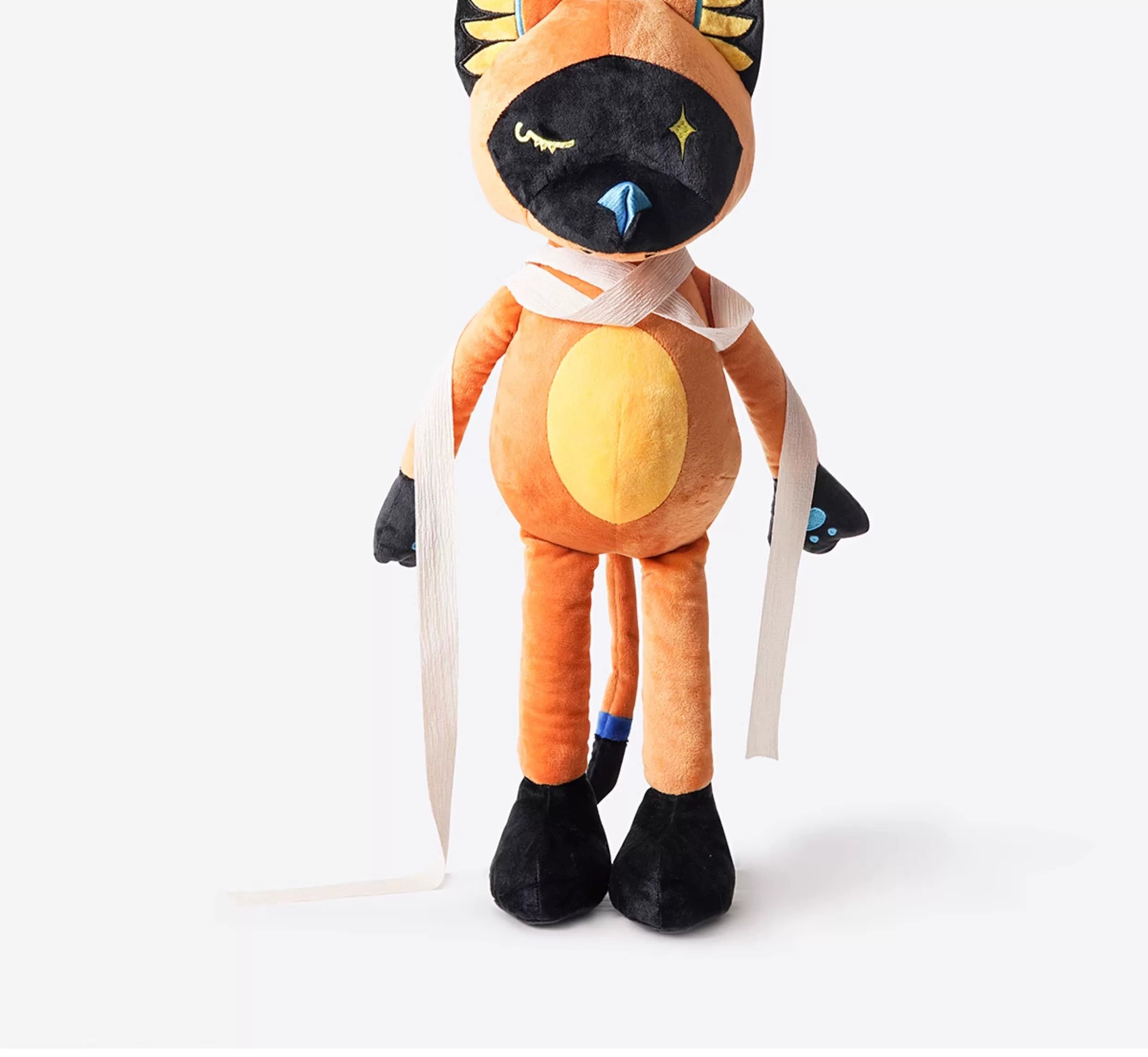 The ZEIO Egyptian Cat Plush Toy – Mystical Soft Stuffed Animal with star eyes, orange and black fur, blue nose, long limbs, and a white scarf—ideal for ancient Egyptian decor enthusiasts.