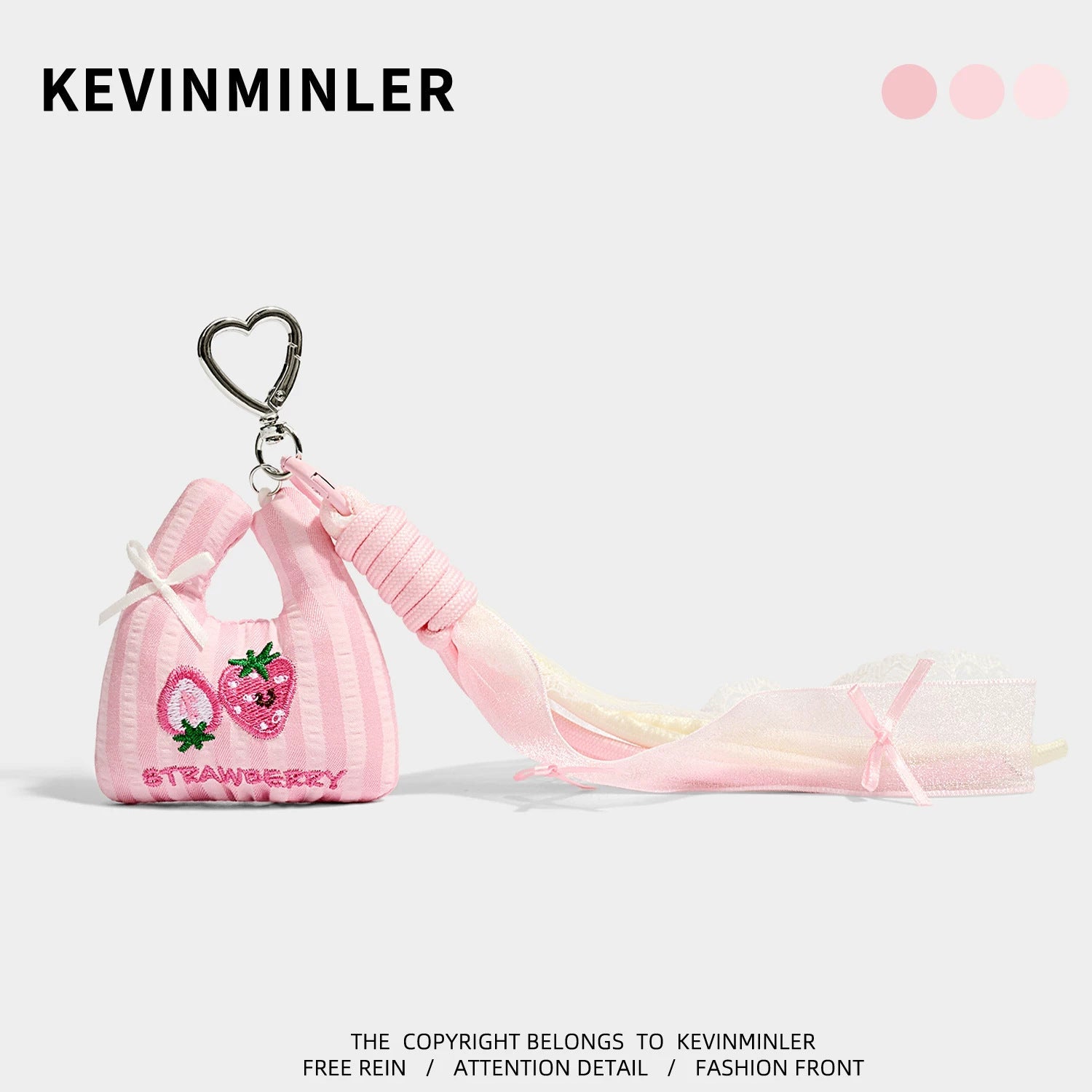 Pink striped mini tote bag charm with two strawberry embroideries, pink gradient strap, and silver heart-shaped carabiner cli