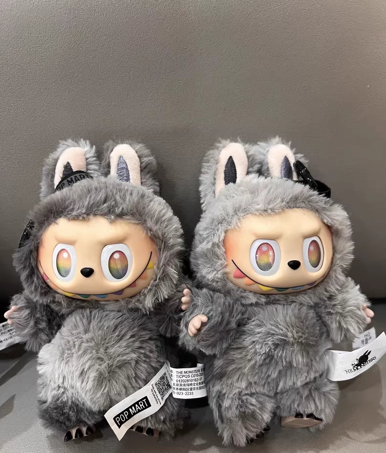 Two POP MART Labubu “Secret Edition” Plush Keychains from The Monsters “Big Into Energy” Series, featuring gray bunny costumes, are displayed side by side against a gray background.