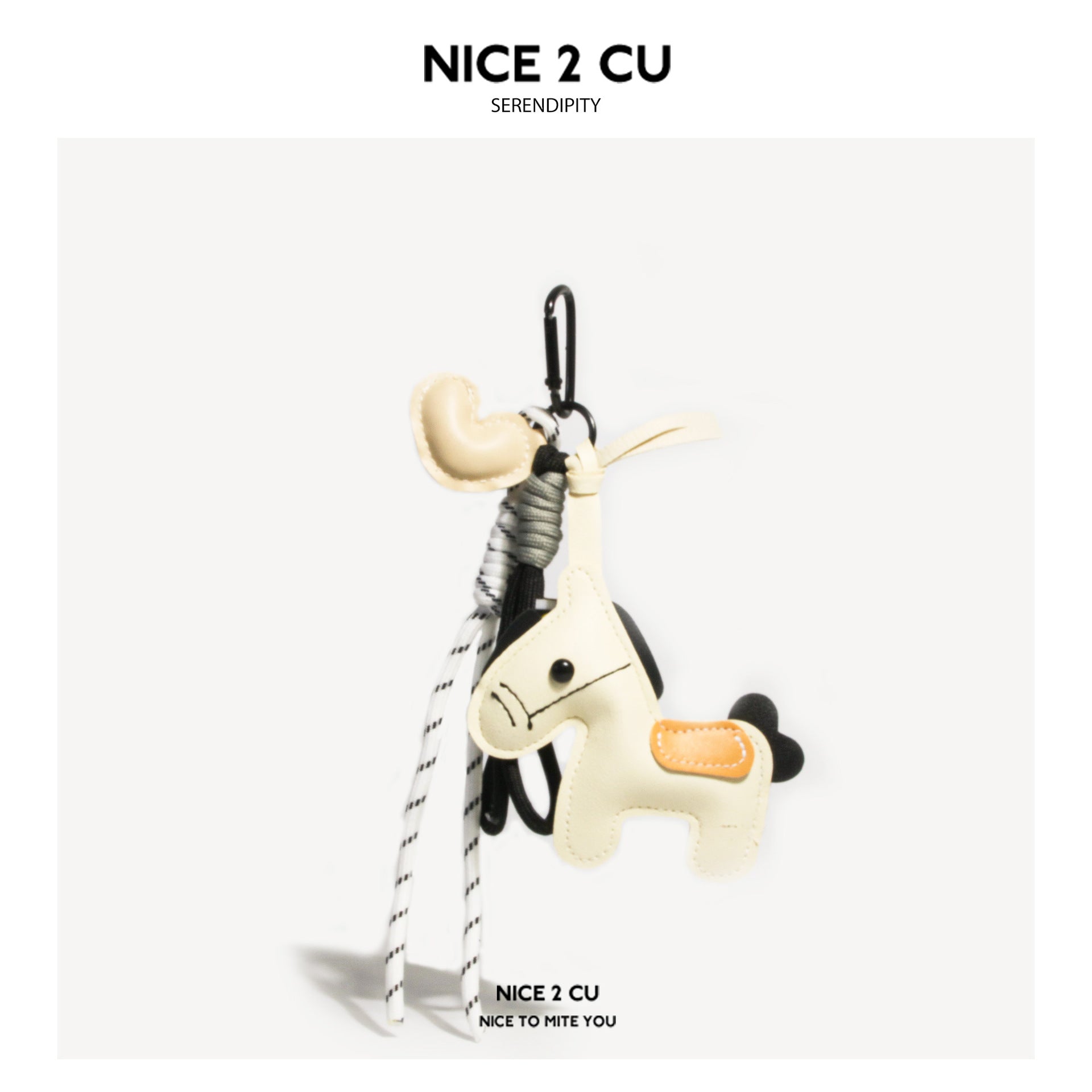 Off-white horse bag charm keychain with cream heart ornament, black-and-white braided cord, and black carabiner clip