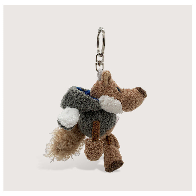 Grey wolf plush keychain charm with brown accents, white paw details, and silver metal clip attachment