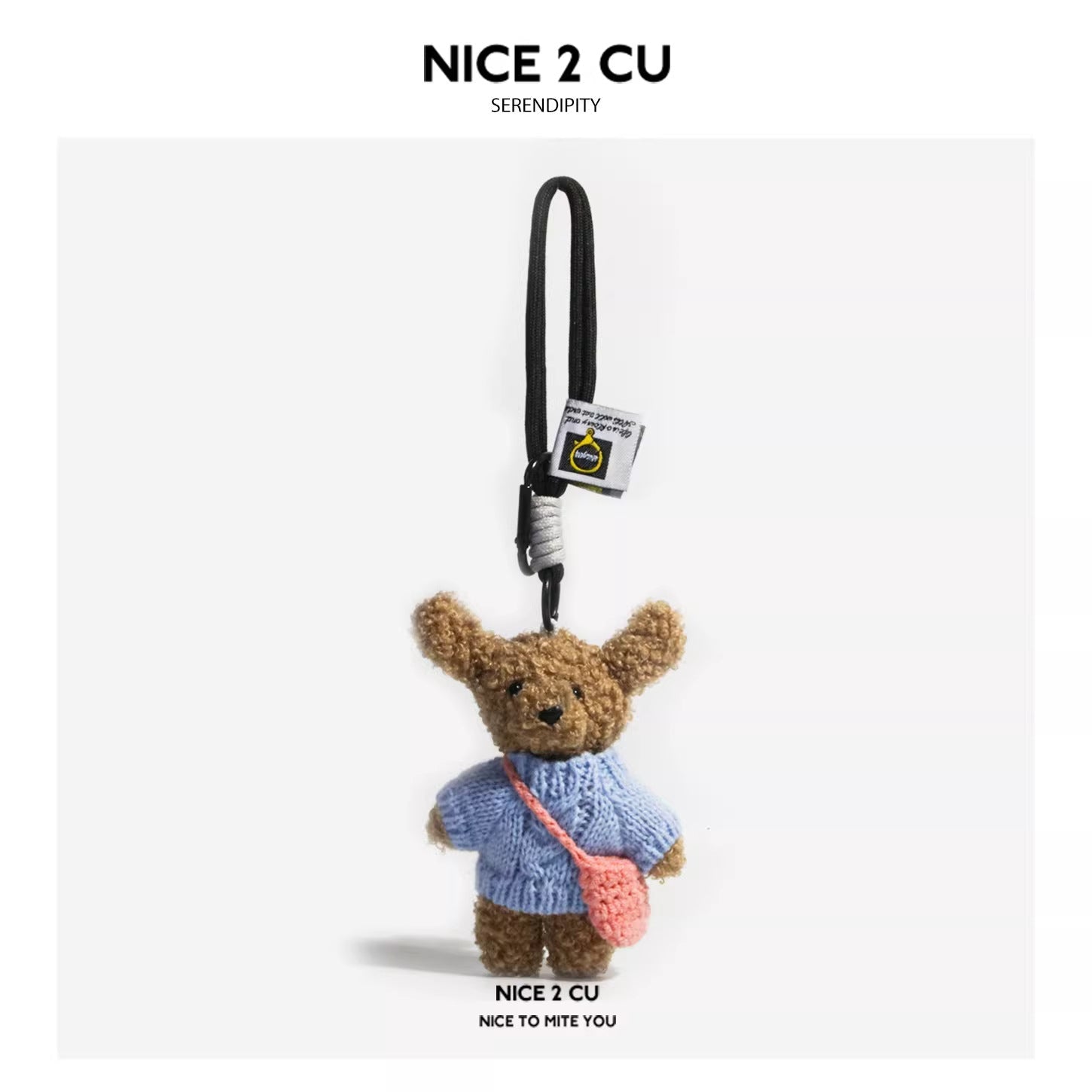 Teddy bear plush keychain in plain light blue sweater with pink mini crocheted crossbody bag on black cord