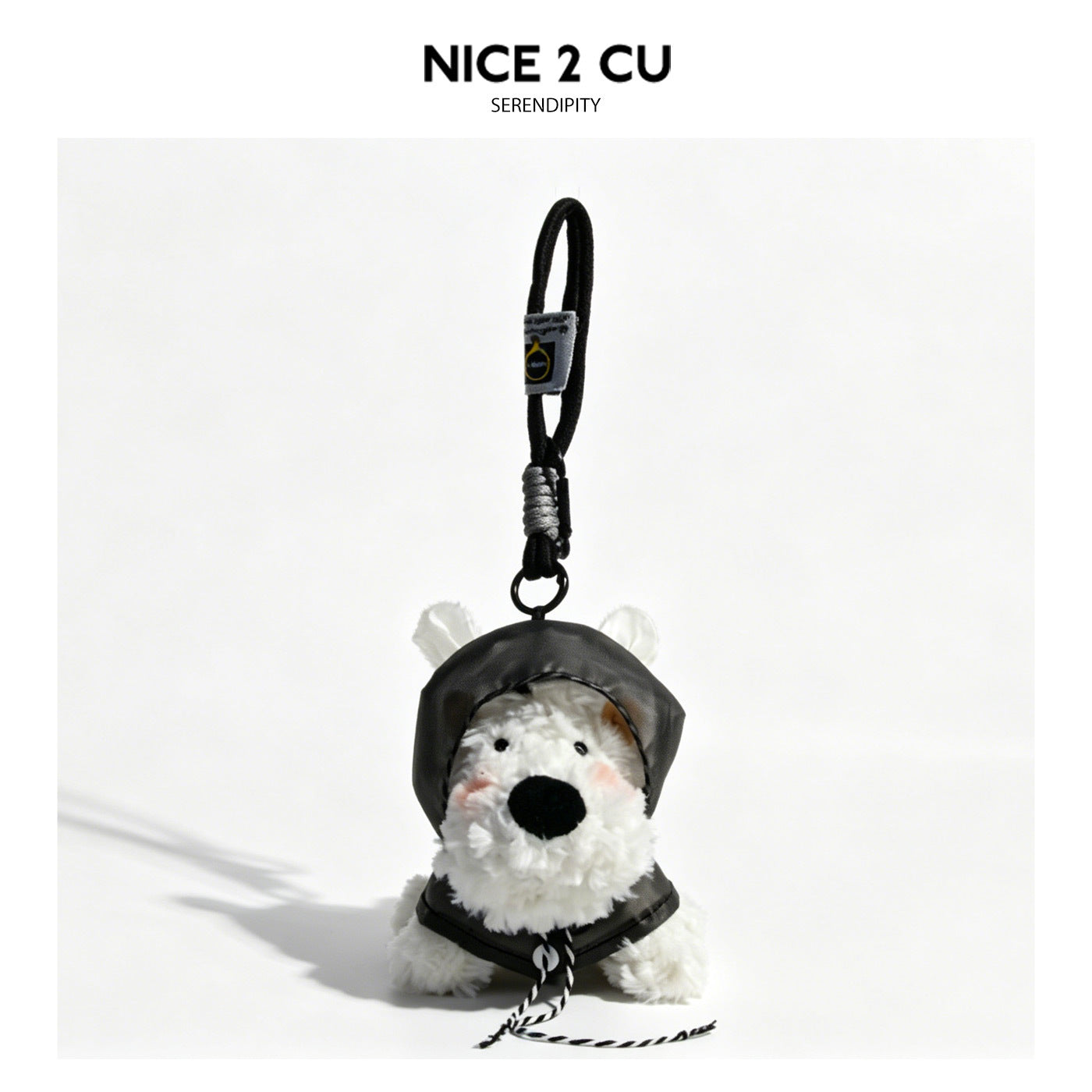 White plush dog keychain charm wearing a black hooded raincoat with white ear-like details