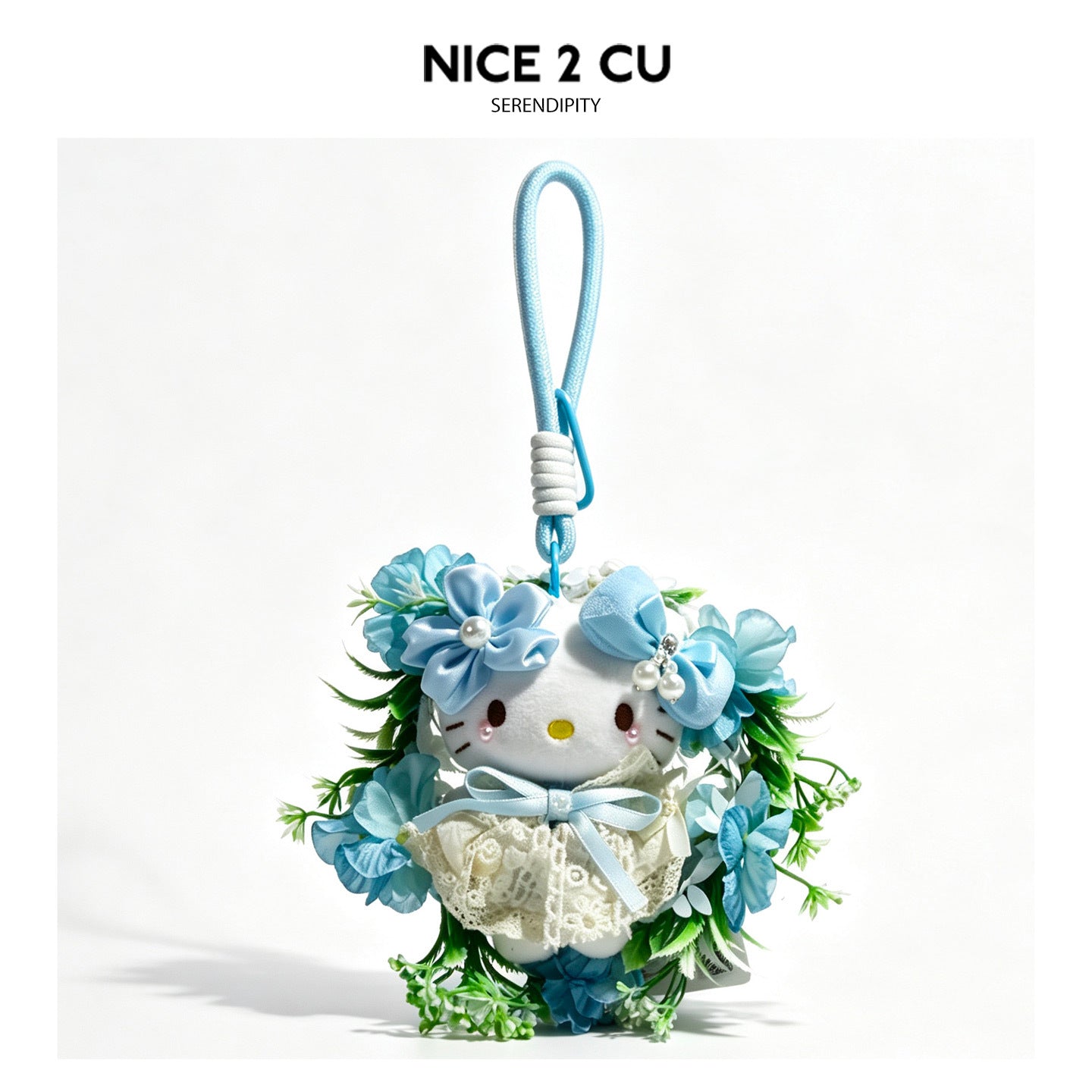 Light blue kawaii cat hanging charm ornament with blue fabric flowers, green foliage, lace dress, and loop strap