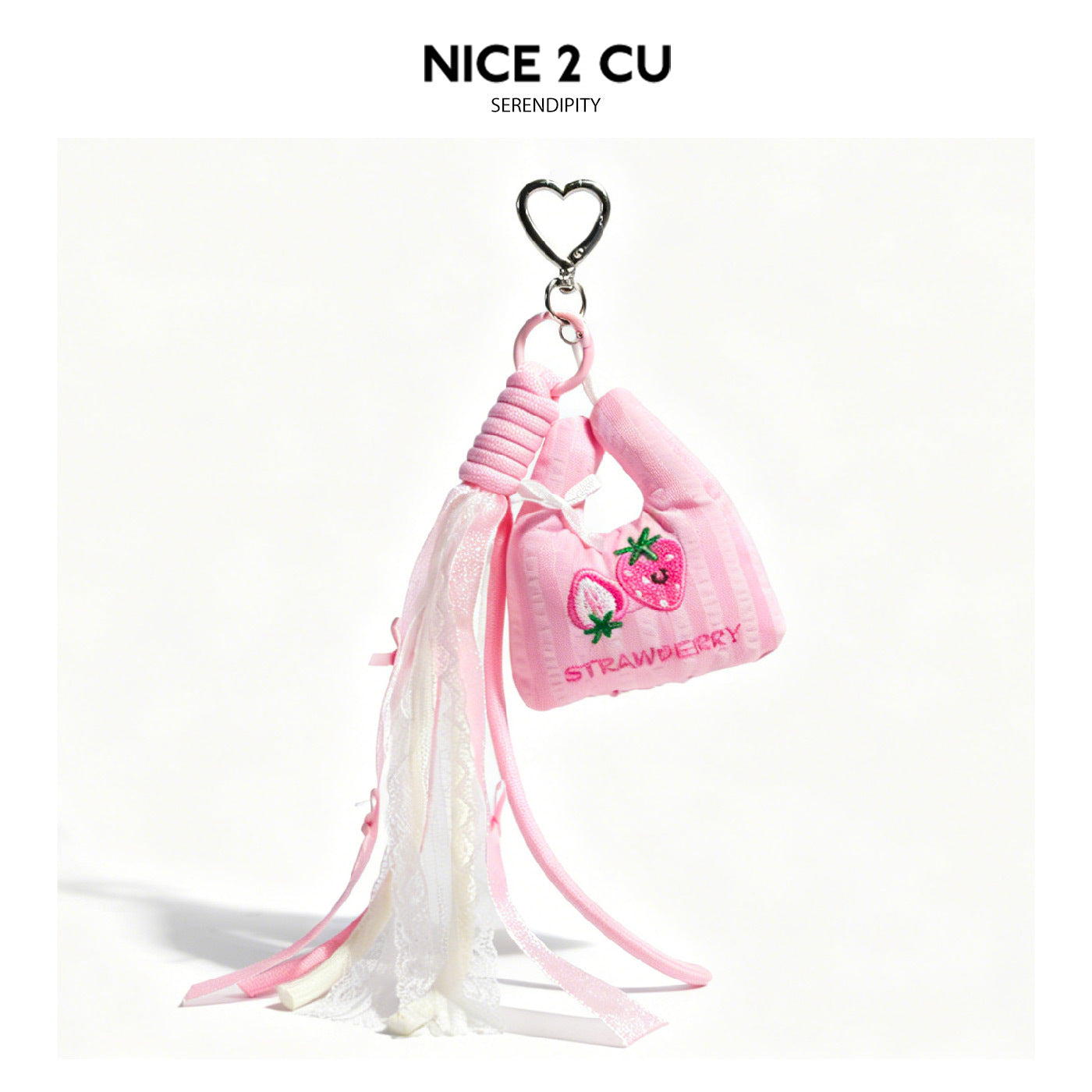 Pink mini bag charm with strawberry embroidery, long flowing sheer white lace drape with pink ribbon accents, and silver hear