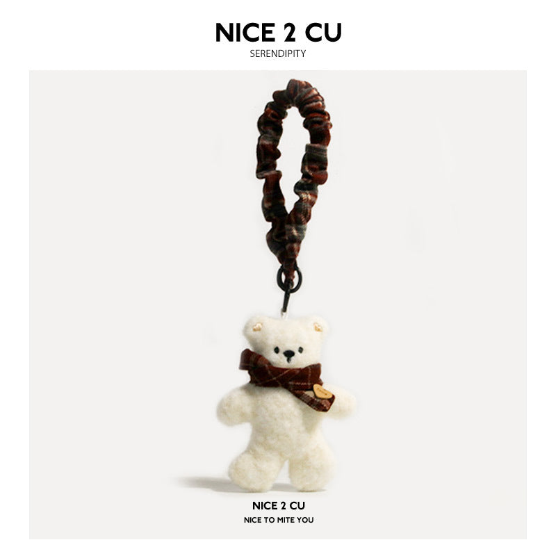 Cream plush bear charm with plaid scarf and long braided wrist strap in coordinating dark plaid tones