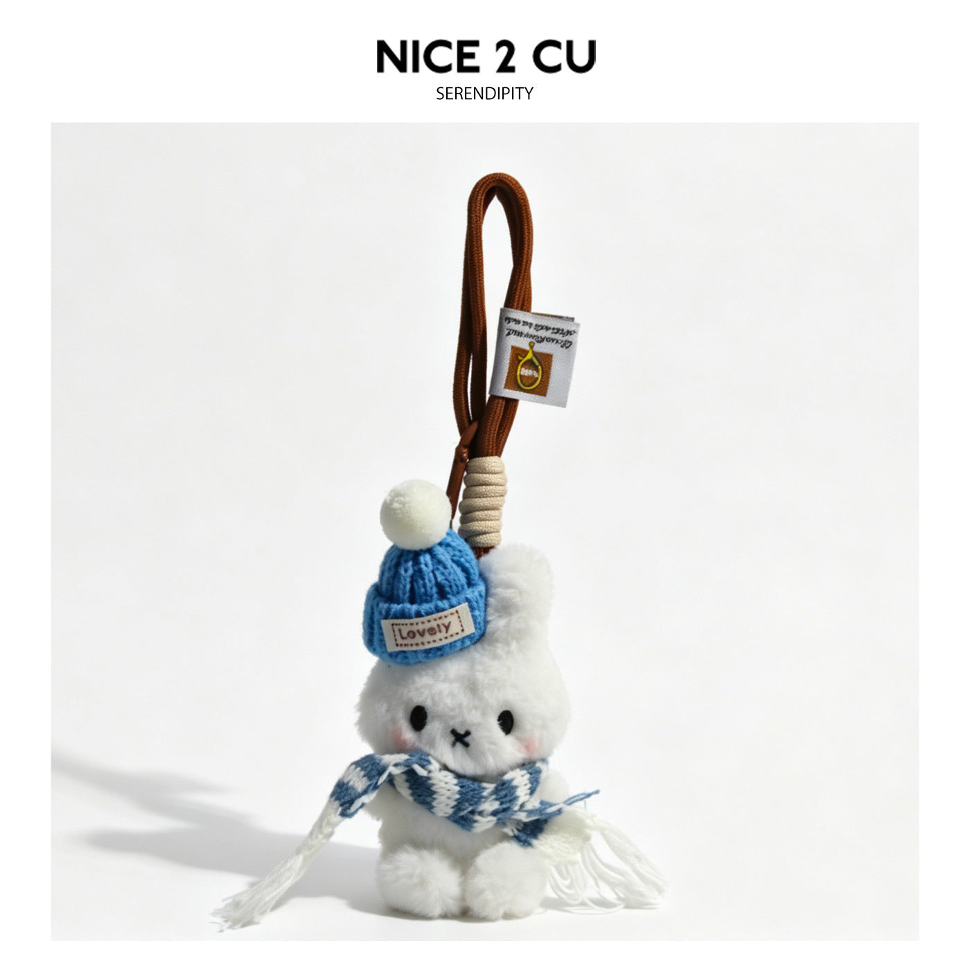White plush bunny bag charm wearing a blue knitted hat with white pom-pom and a blue patterned scarf