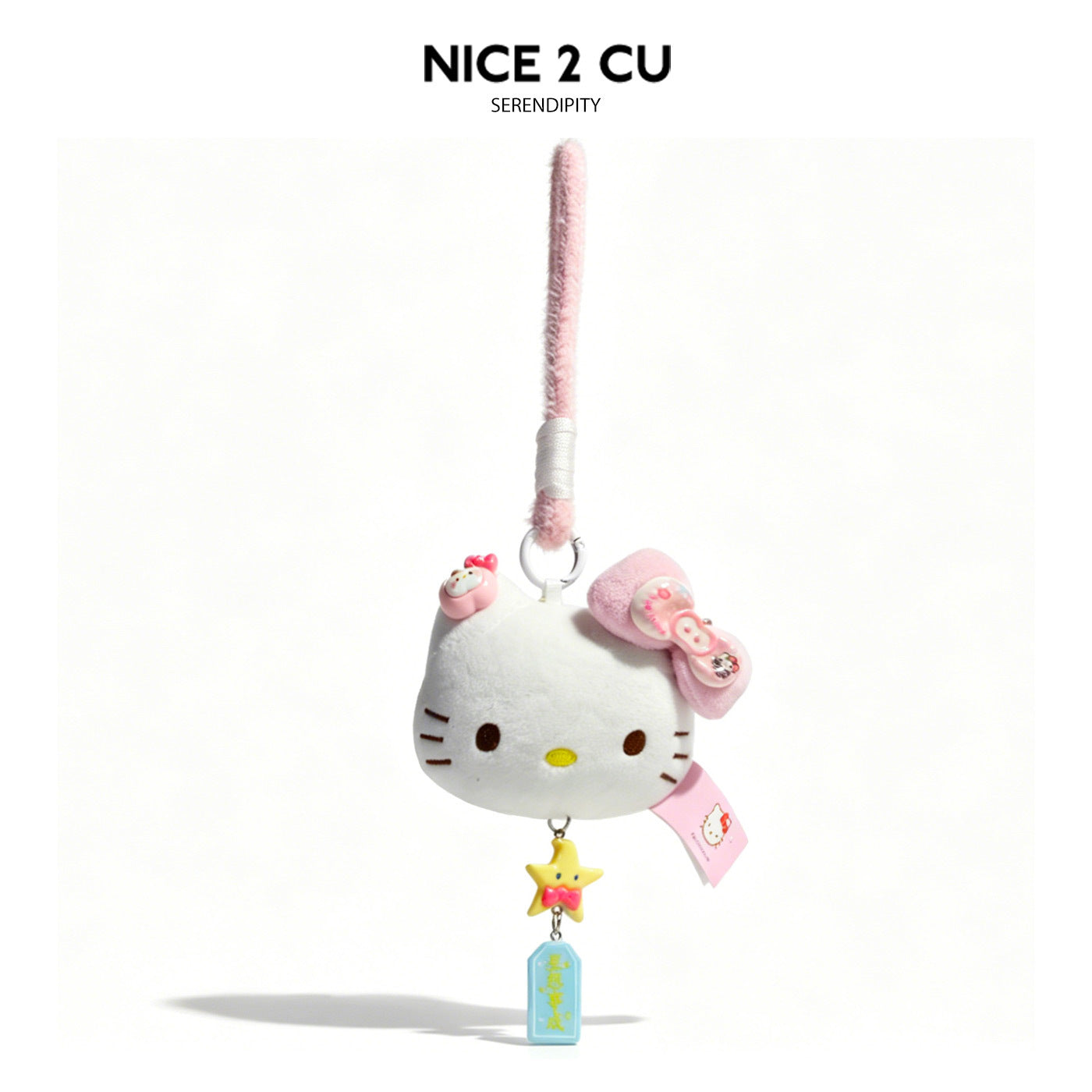 White cat-face plush charm keychain with pink bow, star charm, and blue tag on pink braided cord