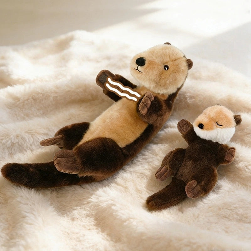 A ZoDoll Otter Plush Toy, a soft 40x12cm sea otter stuffed animal with a removable crab or baby, rests on a cream-colored blanket; the plush's charming design adds adorable style.