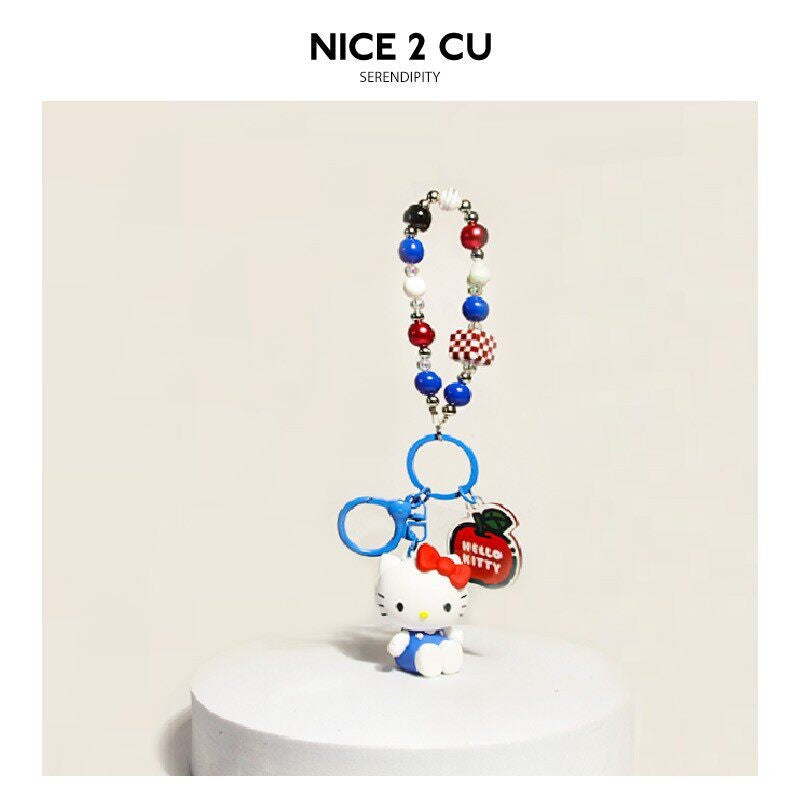 Beaded chain accessory with multicolored beads, small white cat charm, and clip hardware