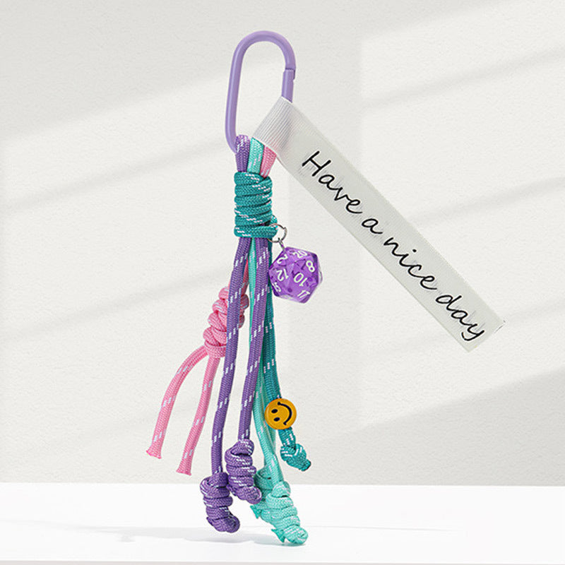 Purple carabiner braided rope bag charm keychain with purple, pink, and teal cord strands and fabric tag