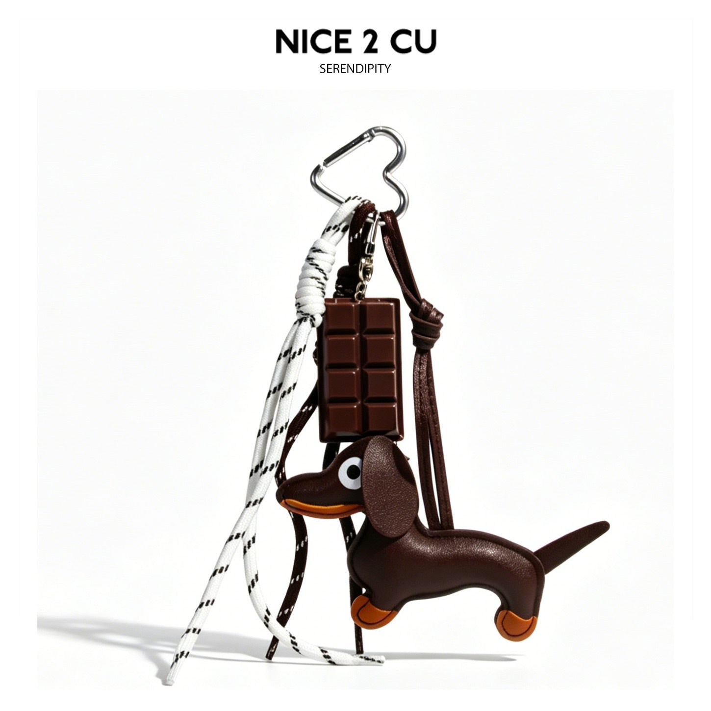 Brown dachshund plush bag charm with chocolate-bar pendant and multiple cords attached to a heart-shaped silver carabiner