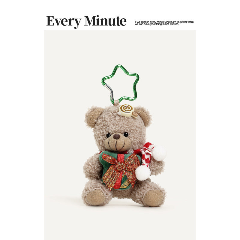Beige plush teddy bear hanging charm with a red-and-white striped scarf, gift box chest decoration, and green star-shaped top