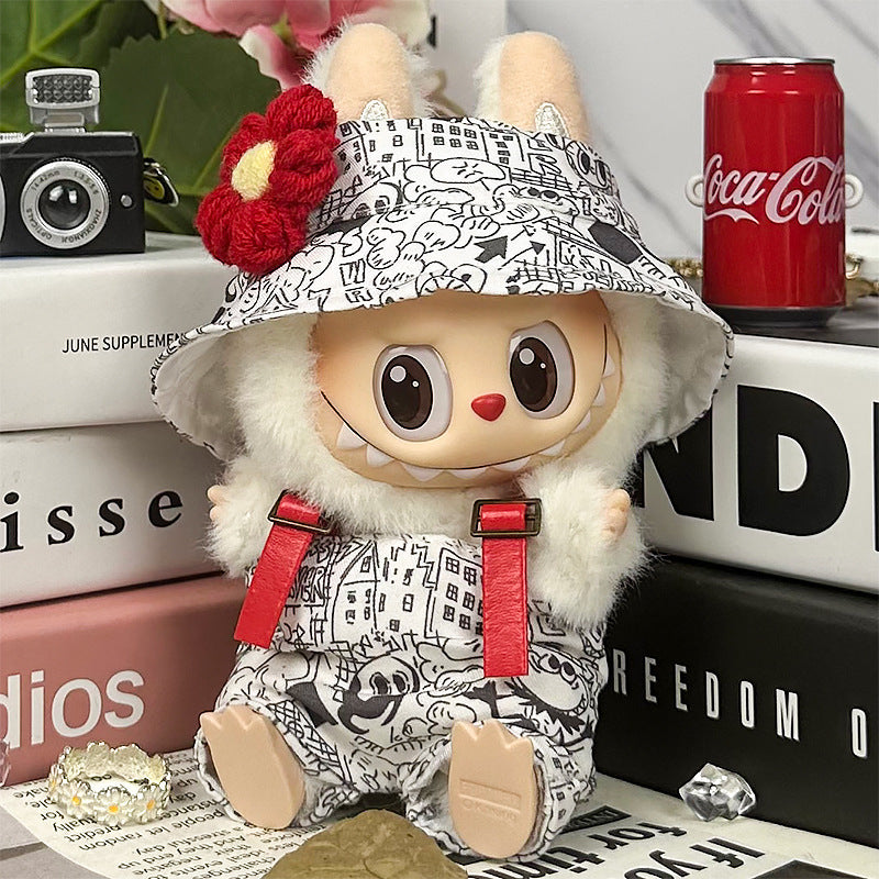 The ZoDoll Labubu Graffiti Print Overalls Set with Hooded Cap and Red Suspenders features a plush toy with bunny ears, large eyes, and a big smile—perfect for your streetwear collection.