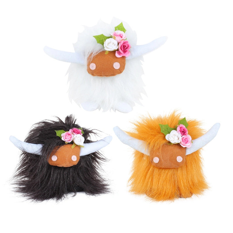 Three ZoDoll Highland Cow Plush Toys with soft long hair, pink bows, and floral crowns are shown in white, black, and orange against a white background. Six colors available.
