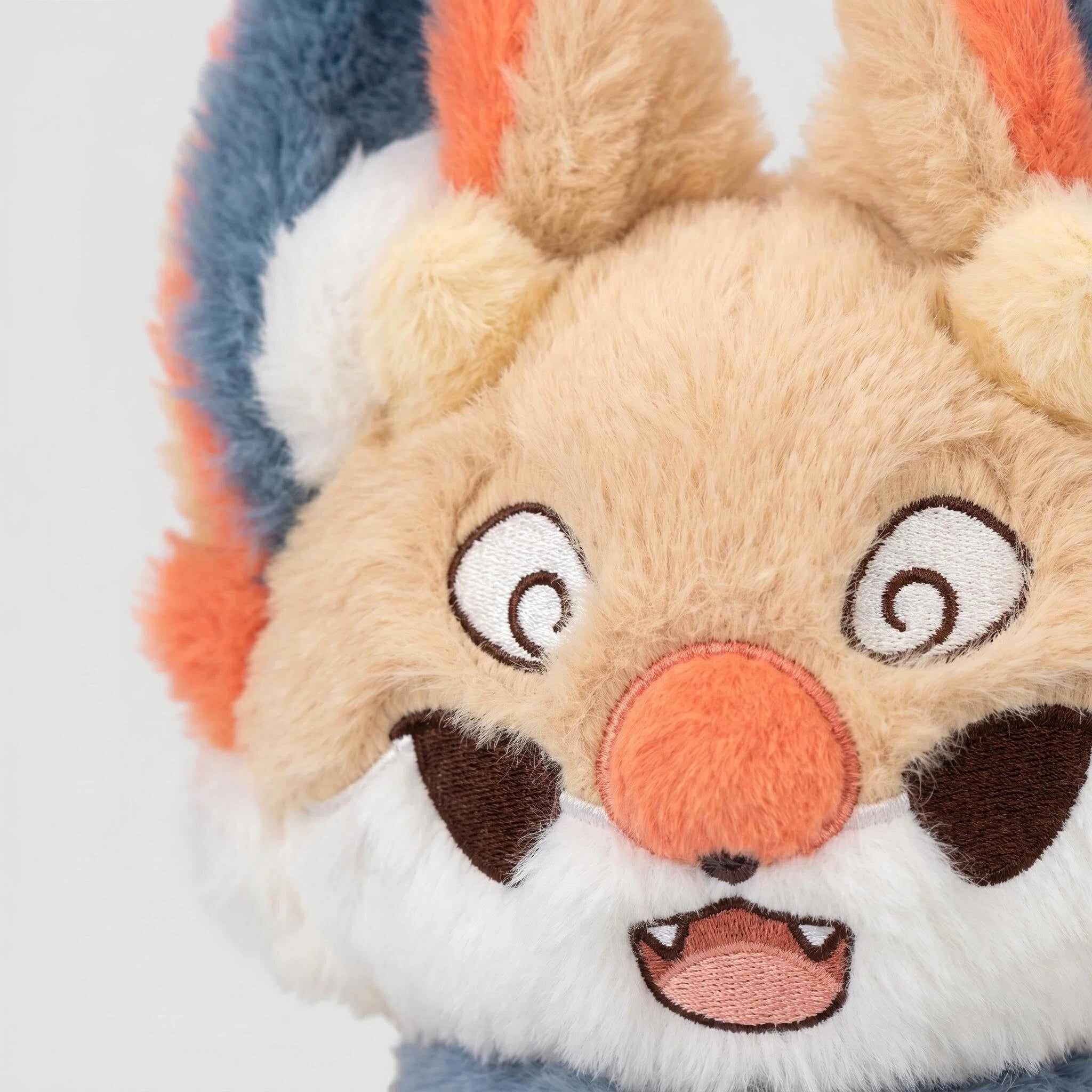 The ZoDoll Fennec Fox Plush Toy features tan and blue fur, big ears, a fluffy tail, orange nose, embroidered spiral eyes, and a kawaii design—an adorable collectible for any plush lover.