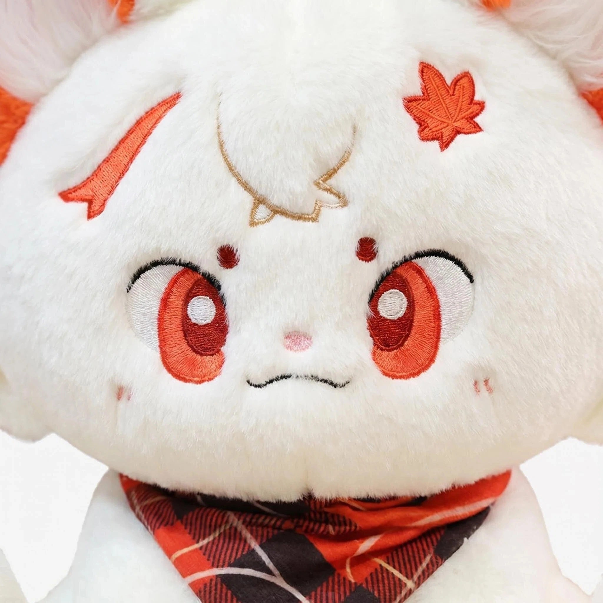 A close-up of the ZoDoll White Fox Plush Toy, a cute fox plush doll with orange ears, a kawaii face, and a red plaid bandana around its neck.