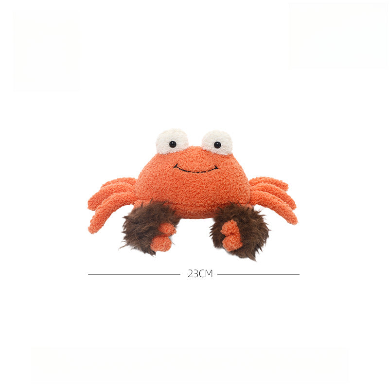 The JOOKI 23cm Orange Crab Plush Toy is a soft, smiling stuffed sea animal with fluffy brown claws and large eyes, shown against a white background.
