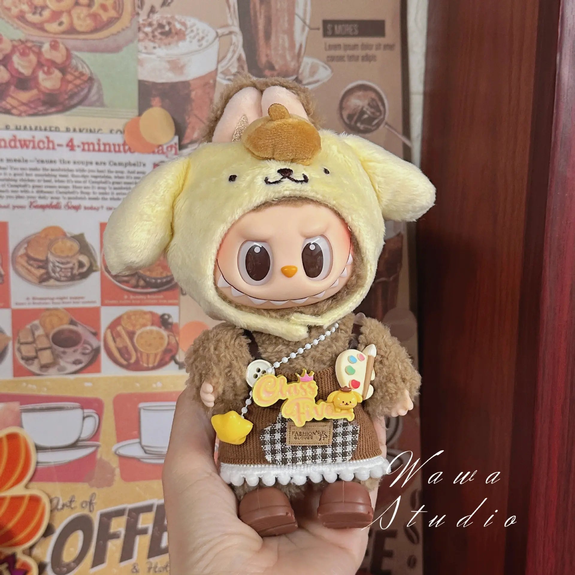 A ZoDoll Labubu Sanrio Doll wears a Hello Kitty Style Outfit Collection, featuring kawaii doll fashion with a Chill Time bag and palette accessory in front of a cafe-themed background.