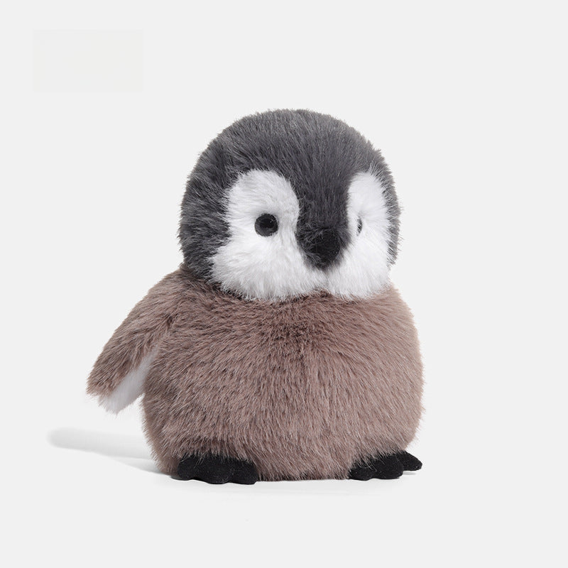 The JOOKI 20cm Baby Penguin Plush Toy features soft grey and white fur—an adorable stuffed animal, ideal for nursery decor.