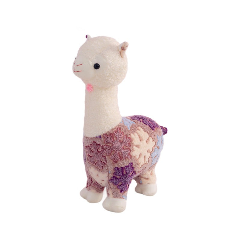 The ZoDoll Flower Alpaca Plush Toy features a soft stuffed alpaca doll with a white head and neck plus a purple and blue patterned body suit—ideal for cuddling or display.