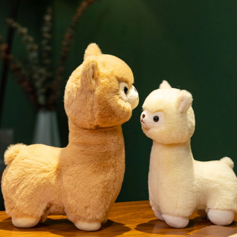 The ZoDoll Cute Alpaca Plush Doll set features one light brown and one white soft alpaca plush toy standing together on a wooden surface, highlighted against a dark green background.