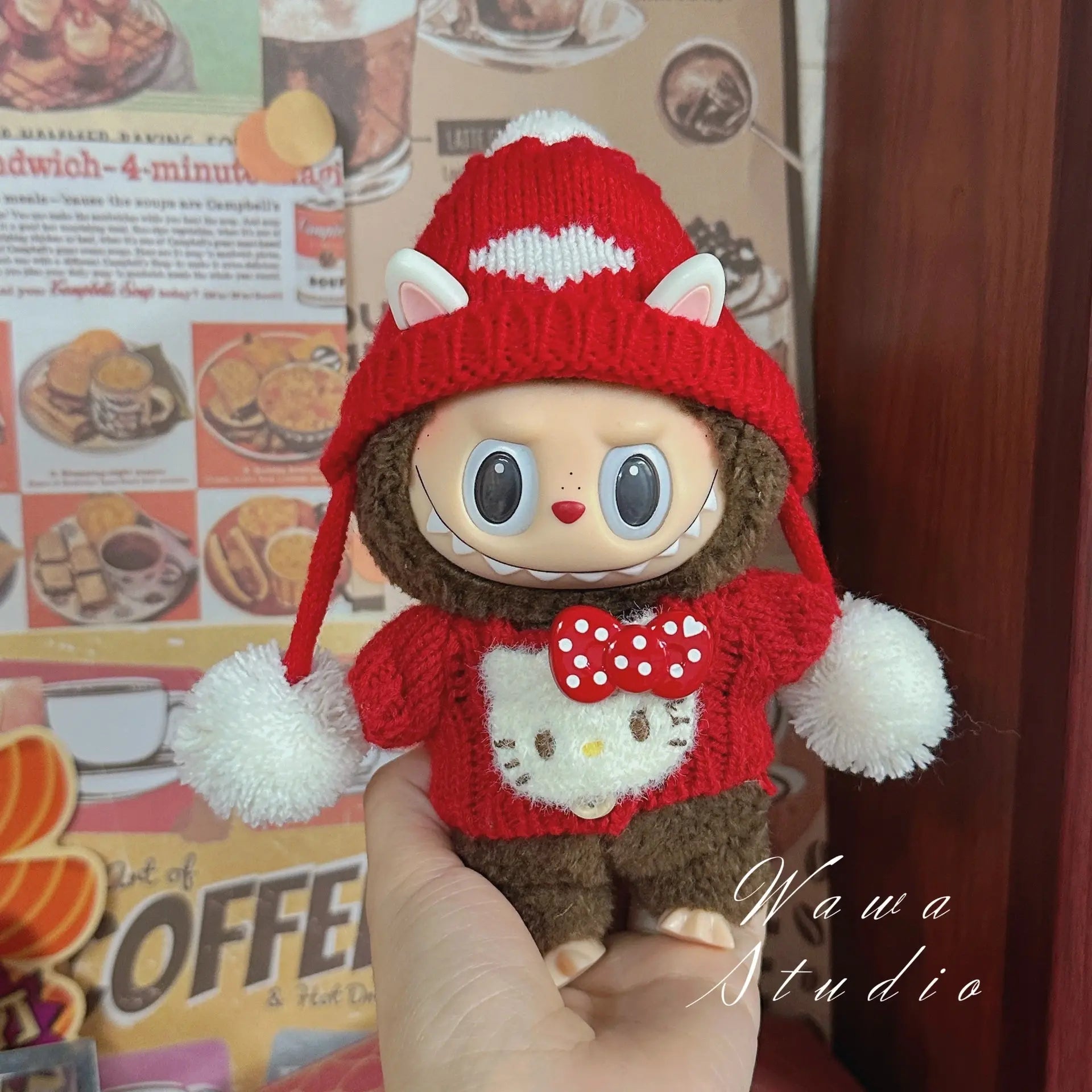 A hand holds a ZoDoll Labubu Sanrio Doll Clothes Set—Hello Kitty Style Outfit Collection—against a retro food poster background. "Wawa Studio" appears on the image.