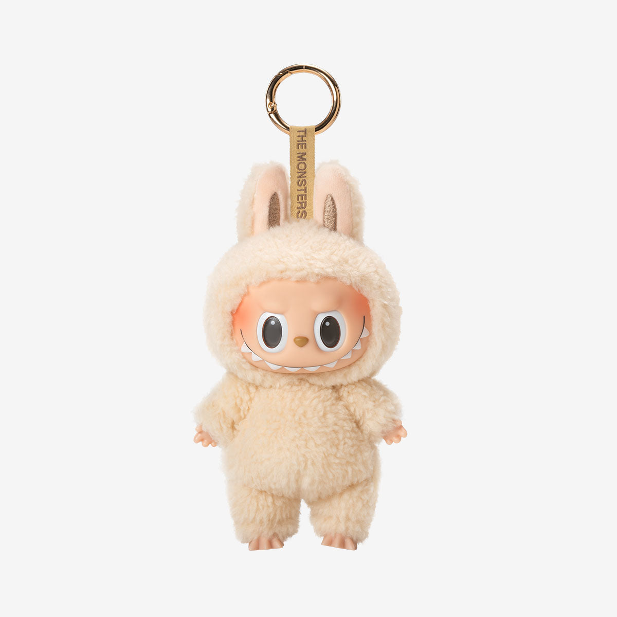The POP MART Labubu “Soymilk” Plush Keychain features The Monsters Beige Bunny Doll with large eyes, a wide smile, soft plush texture, and a gold keyring for easy attachment.